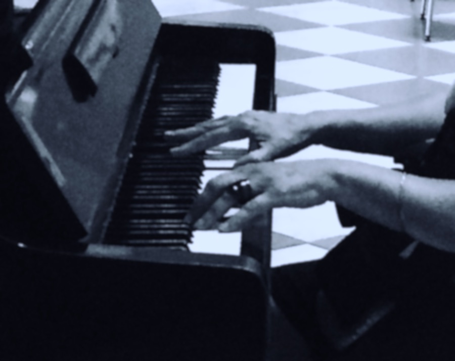 The hands of someone playing a piano. Photography by Traci Gurney